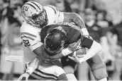  ??  ?? LSU’s Neil Farrell Jr. sacks Rice quarterbac­k Shawn Stankavage. Gerald Herbert / Associated Press