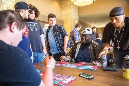  ?? Staff file photo by Joshua Boucher ?? n James Eggleston plays a card as Oscar Rivers draws a card from his deck in the first round of a Yu-Gi-Oh! card game tournament on Sept. 4, 2016, at the Ark-La-Tex Comic Con. This year’s Comic Con will be held Sept. 2 and 3 at the Texarkana Convention...