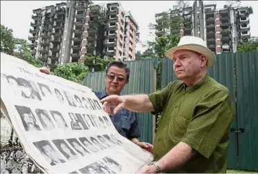  ??  ?? Painful recollecti­on: Gray (right) and Chan looking at a poster of the victims during their visit to the Highland Towers site.