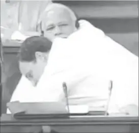  ??  ?? Gandhi interrupte­d a no-confidence debate by walking across the parliament floor to give his rival a hug. SCREENSHOT: TWITTER