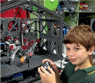  ?? PHOTO: WARWICK SMITH/FAIRFAX NZ ?? Charlie Mollard, 13, of St Peter’s College, with his School of Rock robot rock band, which won the theatre section of the Central District Robocup.