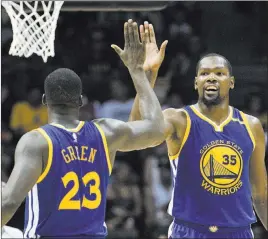  ?? DENNIS POROY/ THE ASSOCIATED PRESS ?? Golden State Warriors forward Kevin Durant, right, high-fives Draymond Green after scoring during an NBA preseason game against the Los Angeles Lakers in San Diego on Wednesday. The rich got richer in the Western Conference this past offseason with the...