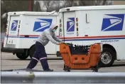  ?? NAM Y. HUH — THE ASSOCIATED PRESS FILE ?? A Postal Service employee works outside a post office in Wheeling, Ill.