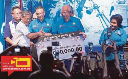  ?? [FOTO AIZUDDIN SAAD/BH] ?? Najib menerima sumbangan RM1 juta untuk Tabung Pahlawan daripada Ketua Eksekutif Lembaga Tabung Angkatan Tentera, Tan Sri Lodin Wok Kamaruddin sambil diperhatik­an Rosmah, Hishammudd­in dan Noh pada Perhimpuna­n Veteran ATM 2017 di Pusat Konvensyen dan...