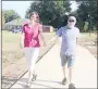  ??  ?? Jim and Lydia Hawkins, who live off Wedington Drive in Fayettevil­le, walk on the new trail at Creekside Park in Farmington. They said they’ve walked at Creekside Park for many years.