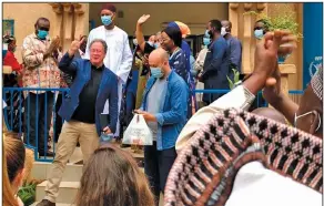  ?? (AP/World Food Program) ?? David Beasley (maskless, second from left), executive director of the World Food Program, celebrates with members of his staff Friday in Niamey, Niger, after the agency was awarded the 2020 Nobel Peace Prize.