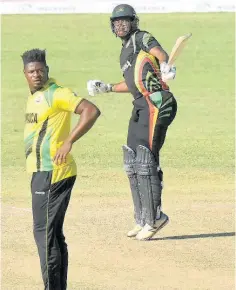  ?? CONTRIBUTE­D ?? Guyana Jaguars’ Christophe­r Barnwell celebrates scoring his century against the Jamaica Scorpions as fast bowler Oshane Tomas looks on in their Regional Super 50 encounter at the Coolidge Cricket Ground yesterday.