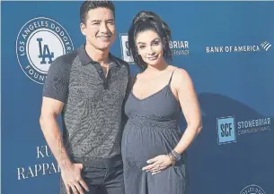  ?? GETTY IMAGES ?? Mario Lopez, seen with wife Courtney, has apologized for comments about children and gender.