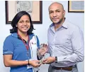  ??  ?? Krystle Reid receives her felicitati­on plaque from Brandix Lingerie CEO Rajiv Malalaseke­ra