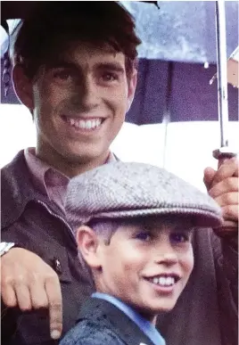  ??  ?? Brotherly love: As Andrew stands beneath an umbrella and Edward, four years his junior, shelters under an outsize tweed cap, the pair are wreathed in smiles. It is 1975 and Andrew is loving life at Gordonstou­n, the tough Scottish school Charles hated. Edward followed him there and also adored the spartan regime.