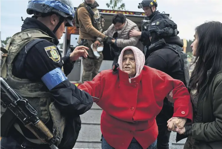  ?? PHOTOGRAPH: KOSTIANTYN LIBEROV/LIBKOS/GETTY IMAGES ?? ▼ An evacuee from Vovchansk, a town nearly surrounded by Russian forces, arrives in Kharkiv