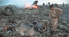  ?? DMITRY LOVETSKY/AP FILE ?? Debris from the downed Malaysia Airlines flight MH17 is strewn near Grabovo, Ukraine, in 2014. The team investigat­ing the incident is suspending its 81⁄2-year inquiry.