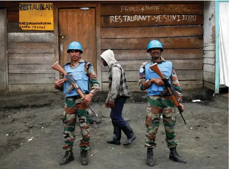  ?? AP ?? UN soldiers stand guard in Goma, Congo. The killings of their comrades have brought calls for justice and action by the DRC