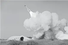  ?? AMIR KHOLOUSI, IRANIAN STUDENTS NEWS AGENCY, VIA AP ?? Iran conducts a missile test in Bushehr on Dec. 29.