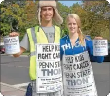  ??  ?? Penn State students Scott Susanin of Bryn Mawr and Kate Palmer of Erie solicit for THON and the fight against pediatric cancer along Newtown’s Sycamore Street.
