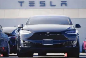  ?? AP FILE PHOTO/DAVID ZALUBOWSKI ?? An unsold 2021 Model X sports-utility vehicle sits at a Tesla dealership in late January in Littleton, Colo.