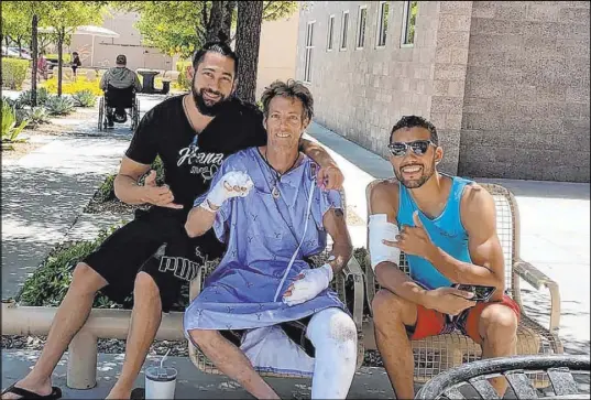  ?? Special to the Las Vegas Review-Journal ?? Mark Bolyea, center, of Salt Lake City, was severely burned during his performanc­e as a fire dancer in Pahrump. Bolyea said he has months of recovery ahead of him and has a GoFundMe account started in his name with a goal of raising $75,000.