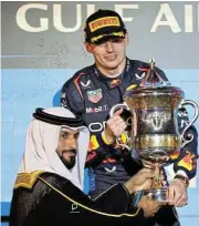  ?? Reuters /Hamad I Mohammed ?? Groundhog day: Max Verstappen receives a trophy from Bahrain Olympic Committee president Sheikh Khalid bin Hamad Al Khalifa after winning the Bahrain Grand Prix. /