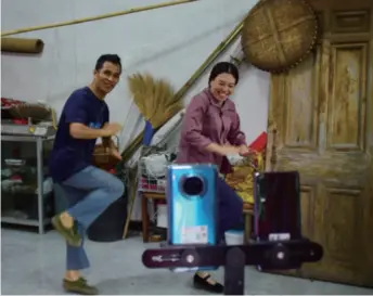  ??  ?? A couple in Mayu, a township in Wenzhou, Zhejiang Province in east China, live-stream themselves dancing on June 1. After the husband suffered depression, his wife helped him recover by dancing with him