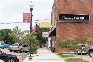  ?? Staff photo by Curt Youngblood ?? The owners of Bubblecraf­t Soapworks and The Beauty Barr on West Broad Street have been fined by the city of Texarkana, Texas, for modifying their buildings’ sign without obtaining a permit.