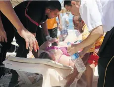  ?? Jawhara FM via the associat ed press ?? Injured people are treated on a Tunisian beach in Sousse on Friday after a gunman opened fire on tourists.