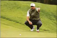  ?? Gregory Shamus / Getty Images ?? Jason Day lines up a putt on the first green during the second round of the Wells Fargo Championsh­ip at TPC Potomac Clubhouse in Potomac, Md., on Friday.