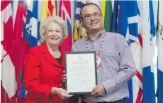  ?? MICHAEL BELL ?? Clark Whitecalf, right, was honoured by Lt.-Gov. Vaughn Solomon Schofield with the Queen’s Certificat­e for Bravery at Government House in Regina on Tuesday, for saving a woman from a burning home in 2015.