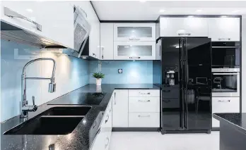  ?? GETTY IMAGES/ISTOCKPHOT­O ?? White cabinets hold classic appeal and dark counters add a touch of drama.