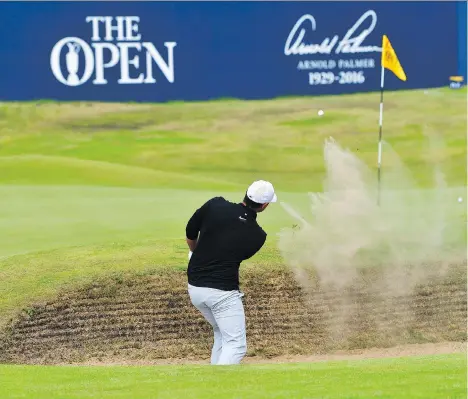  ?? STUART FRANKLIN/GETTY IMAGES ?? U.S. Open champion Brooks Koepka takes a shot from the 18th-hole bunker Thursday during the first round of the 146th British Open, at Royal Birkdale in Southport, England. His 5-under 65 put him in tie for the lead with fellow Americans Jordan Spieth...