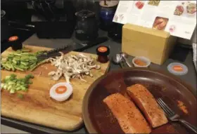  ?? MARTHA BELLISLE — ASSOCIATED PRESS ?? This photo shows the ingredient­s in a togarashi-spiced salmon dish that is one of the choices available as part of Amazon’s new ready-to-cook meal packages.