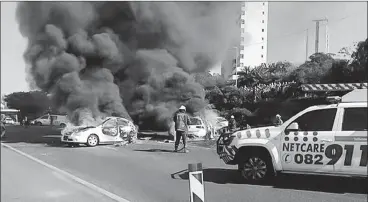  ?? PICTURE: CHRIS BOTHA/NETCARE 911 ?? Firefighte­rs attend to burning vehicles after a deadly crash, while a Netcare 911 vehicle attends the scene at a recent accident. Netcare is well establishe­d in South Africa, but its UK operations are of concern, says the writer.