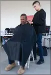  ??  ?? Navy veteran Havilah Johnson gets his haircut from Frank Camarena Thursday, Oct. 25, at the 7th annual Veterans Stand Down and Resource Fair at Veterans Memorial Building in Portervill­e.