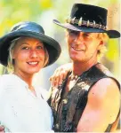  ??  ?? > Paul Hogan with Linda Koslowski in Crocodile Dundee