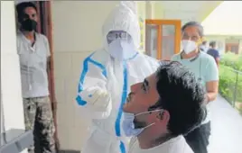  ?? YOGENDRA KUMAR/HT PHOTO ?? ■
A doctor collects swab sample from a man in Gurugram. The number of recoveries in the state crossed the 3,000-mark.