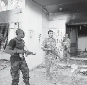  ?? MOHAMMAD HANNON, AP ?? Libyan military guards check on the burnt out U.S. Consulate in Benghazi on Sept. 14.