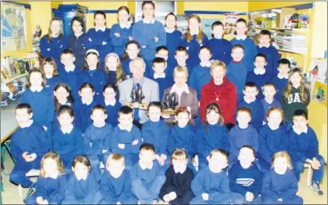  ?? ?? Principal, Tom Murray and Sheila Lane, celebratin­g 25 years teaching at Kilmagner National School, pictured with fellow teacher, Noreen Joyce and pupils from the school having received presentati­ons, 21 years ago.