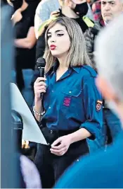  ??  ?? Isabel Medina, 18, wears a blue shirt bearing the fascist Falangist party’s yoke-and-arrows insignia at a commemorat­ion event in a Madrid cemetery