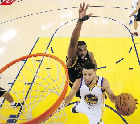  ?? EZRA SHAW/GETTY IMAGES ?? Golden State Warriors guard Stephen Curry goes up for a shot under pressure from Cleveland Cavaliers centre Tristan Thompson in Oakland, Calif., on Thursday. Thompson has averaged nearly nine rebounds a game in the playoffs but had just four in Game 1...