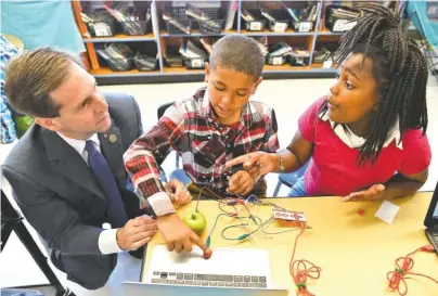  ?? STAFF PHOTOS BY ANGELA LEWIS FOSTER ?? U.S. Rep. Chuck Fleischman­n, left, talks Friday with students Savvian Lemay, center, and Ja’Lyah Griffin at Barger Academy of Fine Arts.