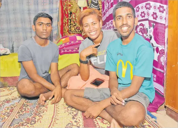  ?? Picture: REINAL CHAND ?? Brothers Rohal Nitij Ram (left) and Jayesh Radhe Mishra with their friend’s wife Gina Palu at Valemasima settlement in Votualevu, Nadi.