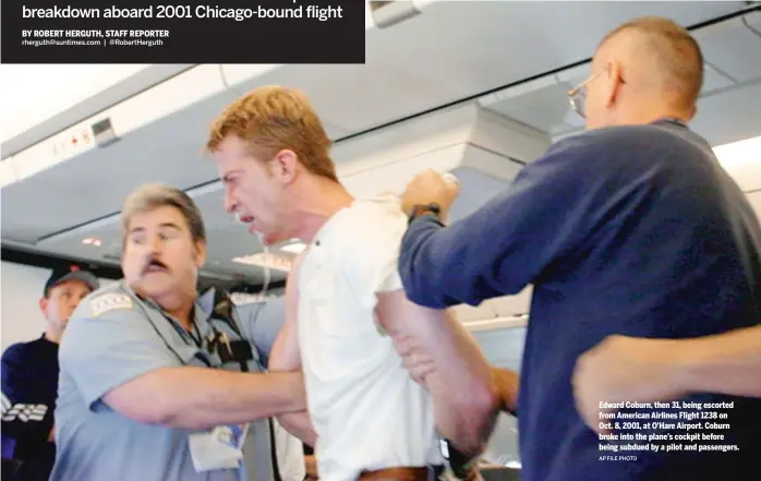  ?? AP FILE PHOTO ?? Edward Coburn, then 31, being escorted from American Airlines Flight 1238 on Oct. 8, 2001, at O’Hare Airport. Coburn broke into the plane’s cockpit before being subdued by a pilot and passengers.