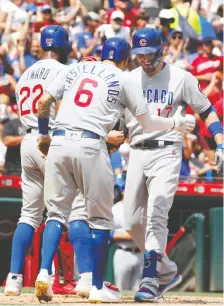  ?? DAVID KOHL/USA TODAY SPORTS ?? The Chicago Cubs’ Kris Bryant, right, celebrates with Nicholas Castellano­s and Jason Heyward after hitting a three-run home run against the Cincinnati Reds earlier this week.