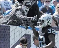  ?? Heidi Fang ?? Raiders defensive back Antonio Hamilton highfives a fan after the team scored in the first quarter against the Tennessee Titans on Sunday in Nashville, Tenn. The underdog Raiders won 26-16.
Las Vegas Review-journal @Heidifang