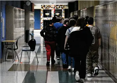  ?? MARSHALL GORBY / STAFF ?? Students at Miamisburg Middle School walk through the hallways May 5. Miamisburg is one of the schools in the region that have added mental health staff and are working to support students and teachers after a difficult two years.