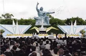  ??  ?? NAGASAKI: Doves fly over the Statue of Peace at Nagasaki Peace Park in Nagasaki, southern Japan during a ceremony to mark the 72nd anniversar­y of the world’s second atomic bomb attack over the city. —AP