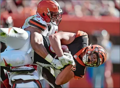  ?? DAVID RICHARD/AP PHOTO ?? Bengals tight end Tyler Kroft (81) is tackled by Browns linebacker Joe Schobert (53) as he catches a touchdown pass in the second half of Sunday’s game at Cleveland. The Bengals won 31-7.