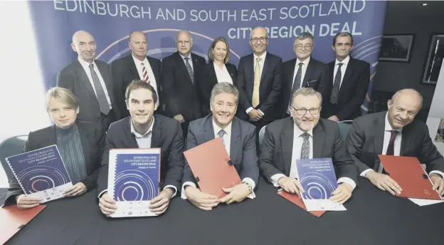  ??  ?? 0 Ministers and councillor­s after signing the Edinburgh and South-east Scotland City Regional Deal last July