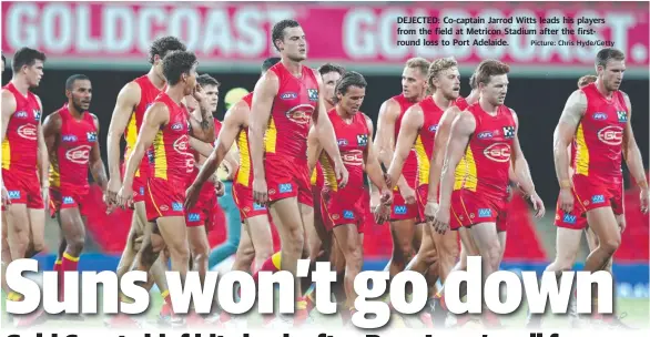  ?? Picture: Chris Hyde/Getty ?? DEJECTED: Co-captain Jarrod Witts leads his players from the field at Metricon Stadium after the firstround loss to Port Adelaide.