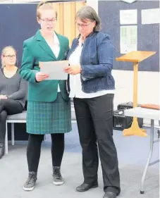  ??  ?? Angela comforts Lile Dean as she reads a poem her mum wrote about Angela’s contributi­on to Totara College.