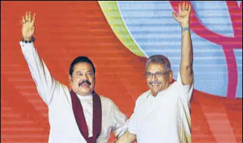  ?? AP FILE ?? Mahinda Rajapaksa (left) and Gotabaya Rajapaksa wave to supporters during a party convention.